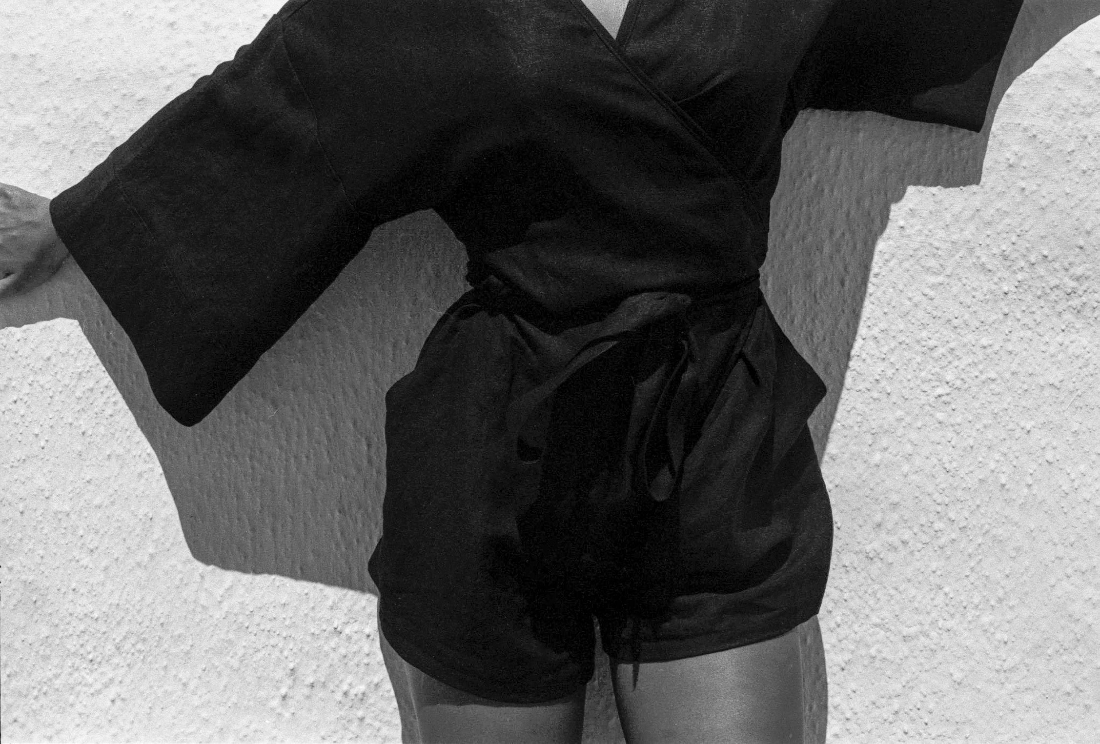 Model wears black linen summer jumpsuit with kimono sleeves