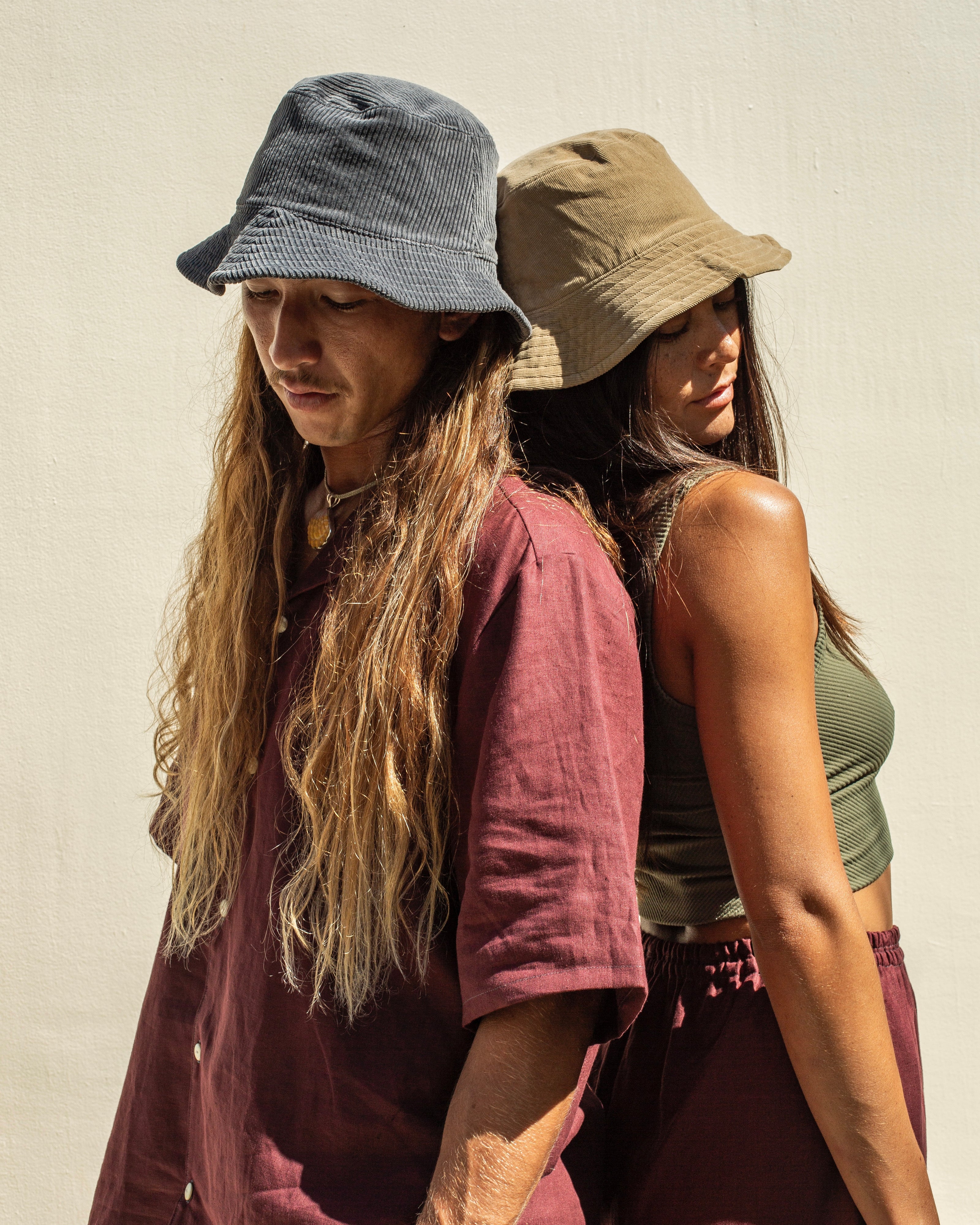 Guy and girl wearing unisex bucket hat in blue and beige corduroy fabrics.